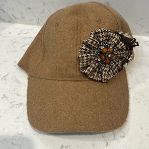 Tweed material hat with broach and flower shaped material
